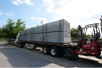 Temporary fencing enclosing an outdoor work area